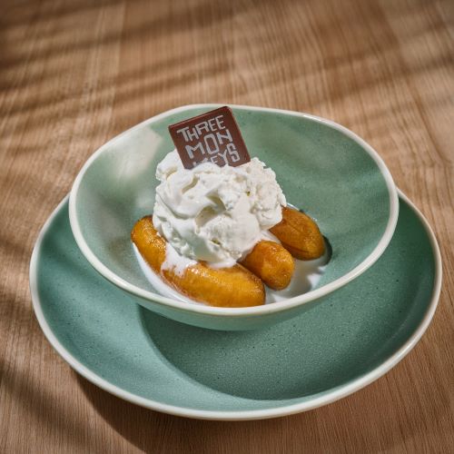 Poached Banana In Syrup Served With Coconut Ice Cream